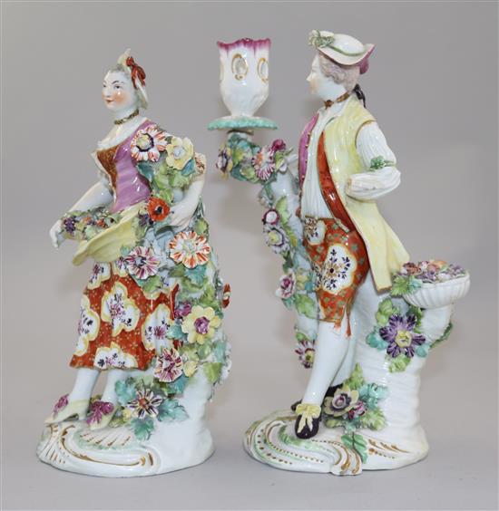 A pair of Derby candlestick figures of a gentleman and a lady, 24cm, damaged